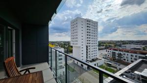 a balcony with a view of a tall white building at APARTAMENT BUŁGARSKA 60m2-3 POKOJE-PIĘKNY WIDOK-13 PIĘTRO 24H CHECK IN in Poznań