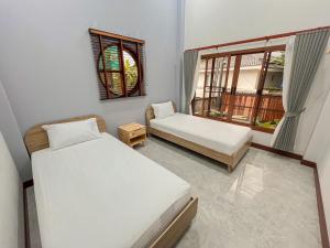 Postel nebo postele na pokoji v ubytování มาเหนือพูลวิลล่า แม่แจ่ม เชียงใหม่ Ma-Nhuer pool villa Mae Chaem Chiangmai