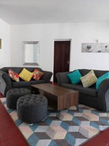 a living room with two couches and a coffee table at Sea whispers in Mombasa