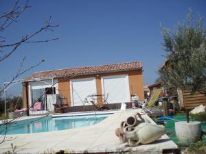 a house with a swimming pool in front of a house at Iris Caromb in Caromb