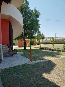 a porch of a house with a tree and stairs at Campo del Gatto in Viterbo