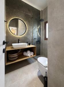 a bathroom with a sink and a mirror at Okeanis Mystique South in Ierápetra