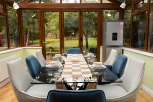 a dining room with a table and chairs at The Limes in Harston