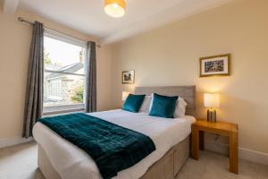 a bedroom with a large bed and a window at The Limes in Harston