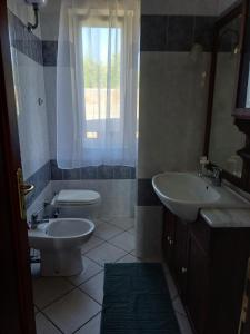 a bathroom with a sink and a toilet and a window at Campo del Gatto in Viterbo +45 photos