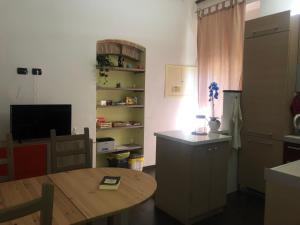 a kitchen and dining room with a table and a television at Vacanza in Chianti in Badia A Passignano