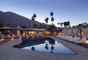 a resort with a pool and chairs and palm trees at L'Horizon Resort & Spa, Hermann Bungalows in Palm Springs