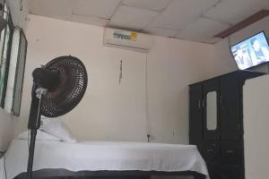 a room with a fan next to a bed at Home Puerto carreño vichada in Cerro el Bita