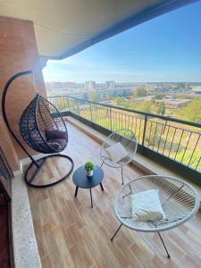 a balcony with two chairs and a swing at Casa Relax con Terrazza Panoramica 2 in Fiumicino