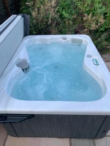a jacuzzi tub sitting on a patio at Red Squirrel Pod with Hot Tub in Oban