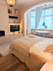 a bedroom with a large bed and a large window at Brookview Guest House in London