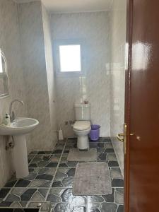a bathroom with a toilet and a sink at villa tulipe in Ain Sokhna