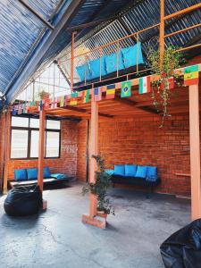 a room with blue couches and a brick wall at Lobo Hostel La Paz in La Paz