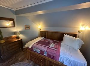 a bedroom with a bed and two lights on the wall at Orcas Hotel in Orcas