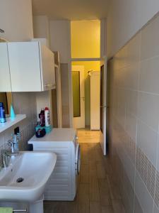 a bathroom with a sink and a toilet and a mirror at Civico 24 Appartamento in centro ad Arona in Arona