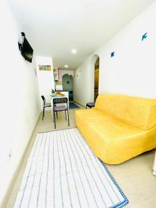 a bedroom with a yellow bed and a table at Casa do Mar in Sesimbra +11 photos