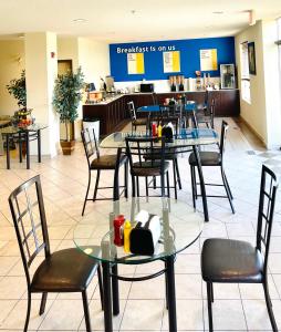 a restaurant with tables and chairs and a cafeteria at Days Inn by Wyndham Grande Prairie in Grande Prairie