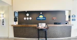 a restaurant with a sign on the wall at Days Inn by Wyndham Grande Prairie in Grande Prairie