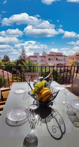 a table with a bowl of bananas and wine glasses at Casa Palmu apartment - A peaceful and relaxing oasis in Golf del Sur, Tenerife in San Miguel de Abona