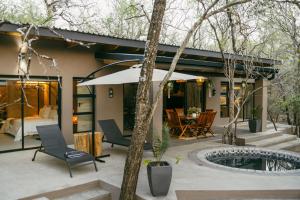 a house with a courtyard with a pool and a bedroom at Leopard's Khaya, Marloth Park in Marloth Park
