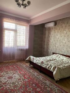 a bedroom with a bed and a rug at Nice villa in Yerevan