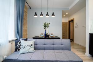 a living room with a blue couch and a table at Apartment in Vilnius Center in Vilnius