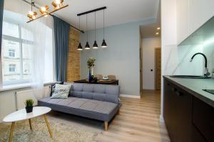 a living room with a couch and a kitchen at Apartment in Vilnius Center in Vilnius