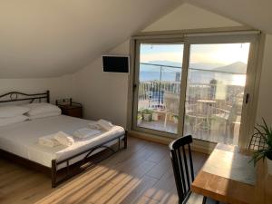 a bedroom with a bed and a large window at studio Palerostravel in Paleros