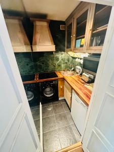 a small kitchen with a stove and a sink at Perfect West End Launchpad in London