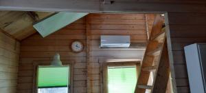 a room with a wall with a clock and two windows at Sabine's Wellnesslodge in Ruppertsweiler +18 photos