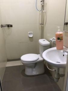 a bathroom with a toilet and a sink at Homestay Taman Tiara Paka in Paka