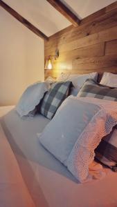 a large bed with several pillows on it at Guest Accommodation Butina in Kuterevo