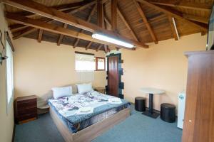 a bedroom with a bed and a table in it at Madjestic Houses in Batak