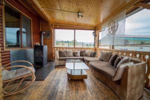 a living room with a couch and a table at Madjestic Houses in Batak