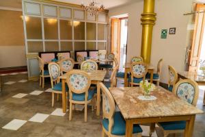 a dining room with wooden tables and chairs at Adamas House Hotel Boutique in Quito