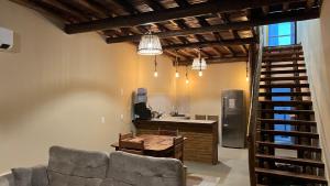 a living room with a couch and a kitchen at Apartamento Beira Mar Preá in Prea +13 photos