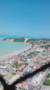 an aerial view of a city and the beach at Ponta Negra RN02 in Natal