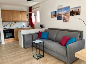 a living room with a couch and a table at Düne 13 in Wangerooge
