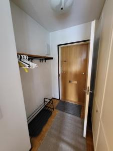 an empty hallway with a wooden door and a staircase at Beautiful studio - easy check-in, free parking & wifi in Rovaniemi