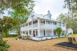 a large white house with a large yard at Vintage Grove in Clermont