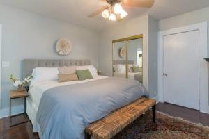a bedroom with a large bed with a bench at Vintage Grove in Clermont