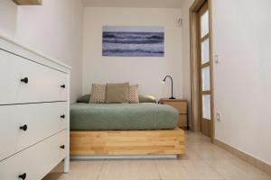 a bedroom with a bed and a dresser at Belair Lloret Sun & Beach in Lloret de Mar