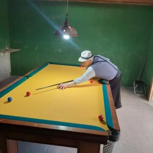 Un homme joue au billard dans l'établissement Embu Manacás da Serra, à Embu