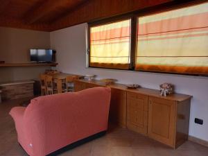 a living room with a red couch and a window at Sulla mansarda di Gina in Palagiano