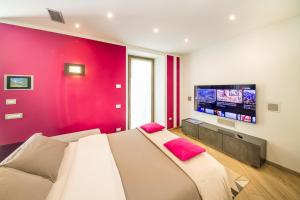 a room with a couch and a flat screen tv at Luna Nuova in Tirano