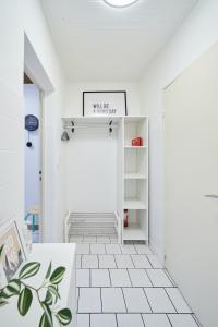 a white hallway with a white tiled floor at L'Alsacien Zen in Mulhouse