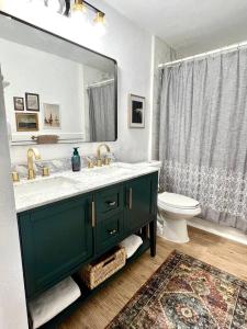 a bathroom with a sink and a toilet and a mirror at Retreat on the Island in Merritt Island