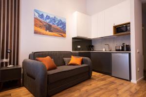 a living room with a couch and a kitchen at New Gudauri Luxury Studio in Gudauri