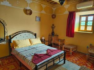 Postel nebo postele na pokoji v ubytování Kasbah Imini Restaurant & Hotel