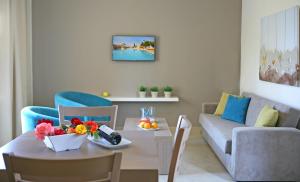 a living room with a table and a couch at Makronisos Village in Ayia Napa